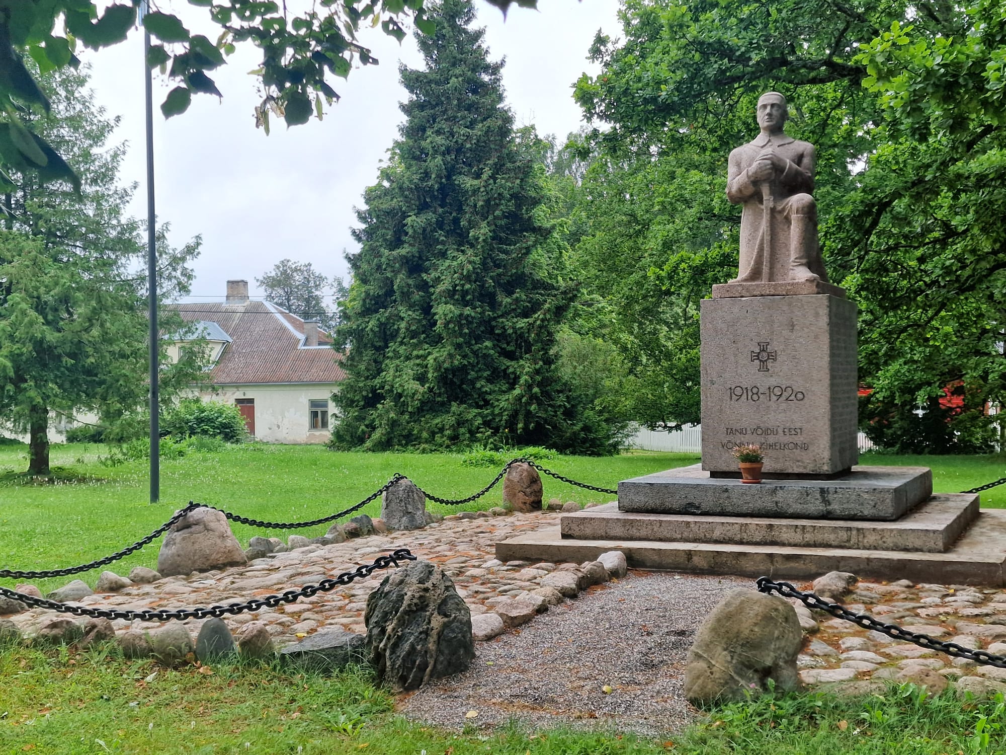 Monument to the War of Independence in Võnnu - a stone-carved sculpture of a figure holding a sword with both hands, its blade resting on the ground.