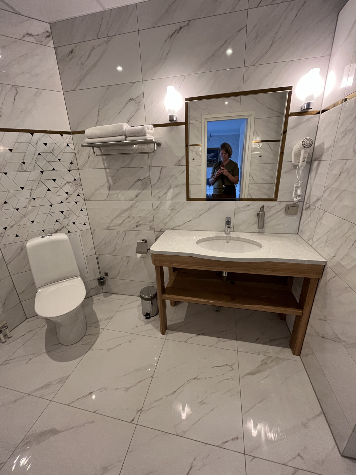 Toilet on the left hand, washbasin in the middle with a mirror on the wall and shower on the right